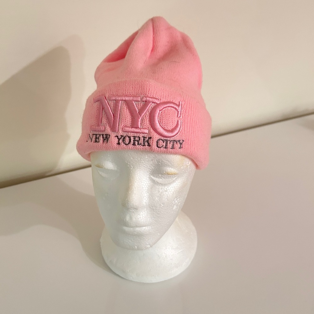 Women light pink color knitted NYC logo beanie. 100% acrylics. OS. New.